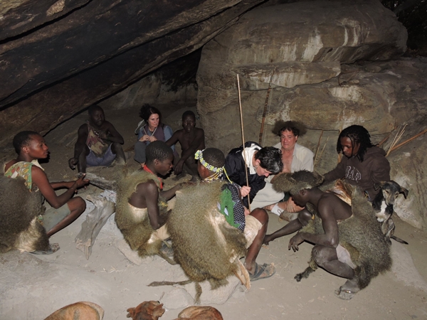 Hadzabe Bushmen meet in the communal cave at 6am, preparing to hunt in Tanzania's Rift Valley